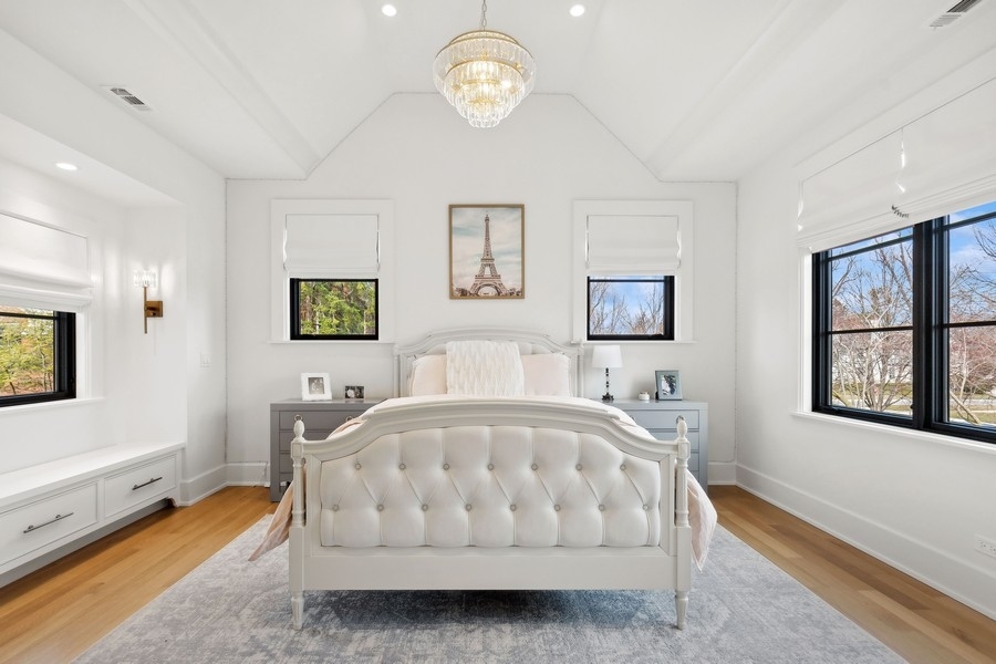 240 Raleigh Road Kenilworth, IL 60043 - Photo 40 of 71 a white bed sitting in a living room next to a window