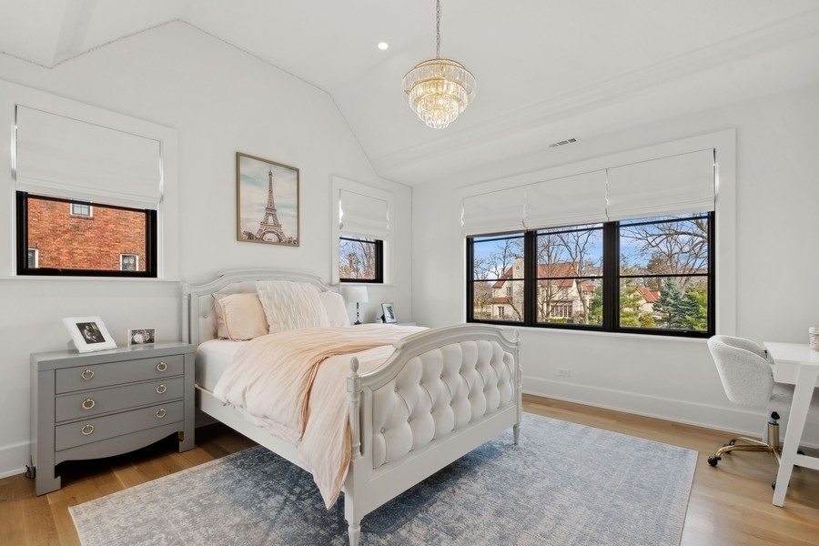 240 Raleigh Road Kenilworth, IL 60043 - Photo 41 of 71 a bedroom with a bed a table and painting on the wall