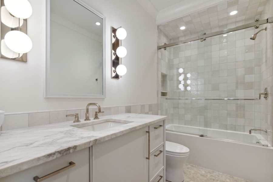 240 Raleigh Road Kenilworth, IL 60043 - Photo 42 of 71 a bathroom with a sink a toilet and shower