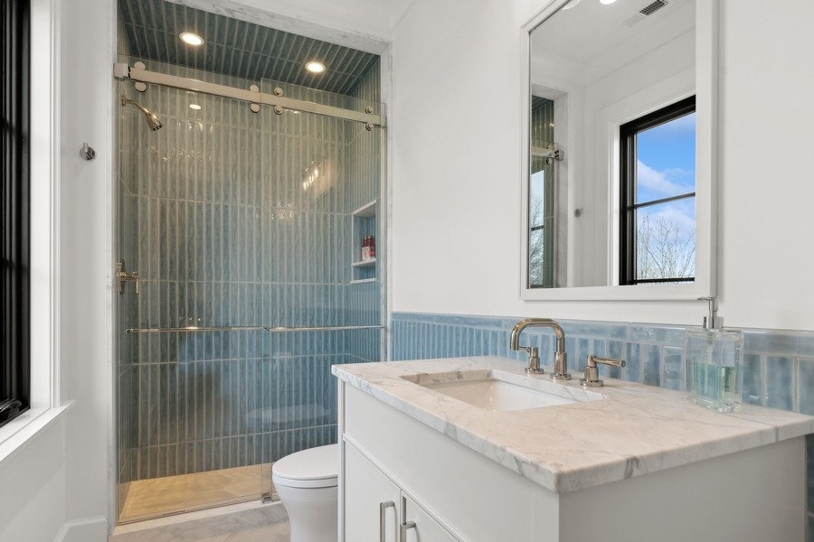 240 Raleigh Road Kenilworth, IL 60043 - Photo 47 of 71 a bathroom with a sink toilet and shower