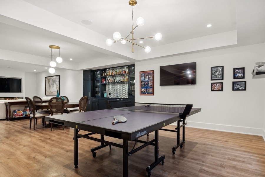 240 Raleigh Road Kenilworth, IL 60043 - Photo 53 of 71 a living room with furniture and a flat screen tv