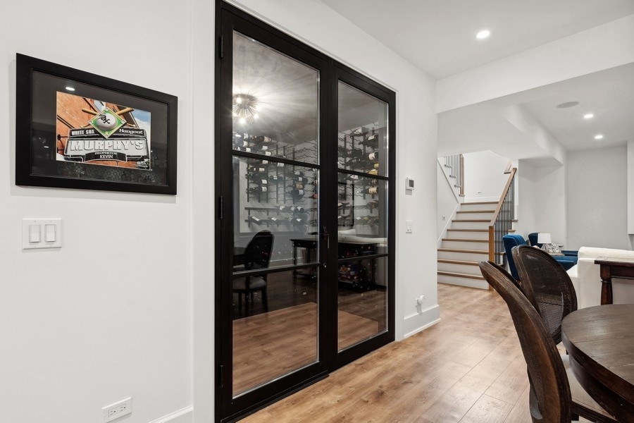 240 Raleigh Road Kenilworth, IL 60043 - Photo 55 of 71 a view of a hallway with couches and dinning table with wooden floor