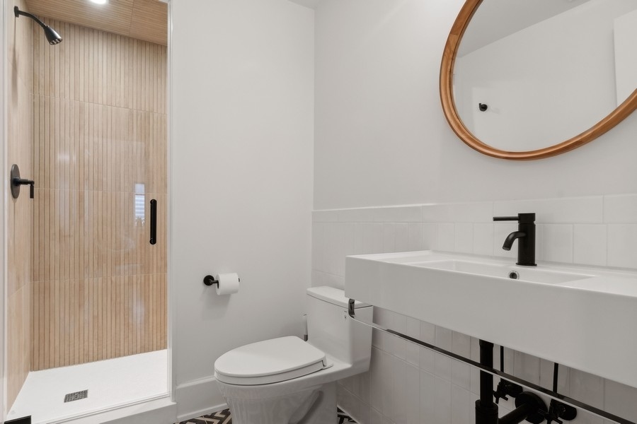 240 Raleigh Road Kenilworth, IL 60043 - Photo 59 of 71 a bathroom with a toilet a sink and a mirror