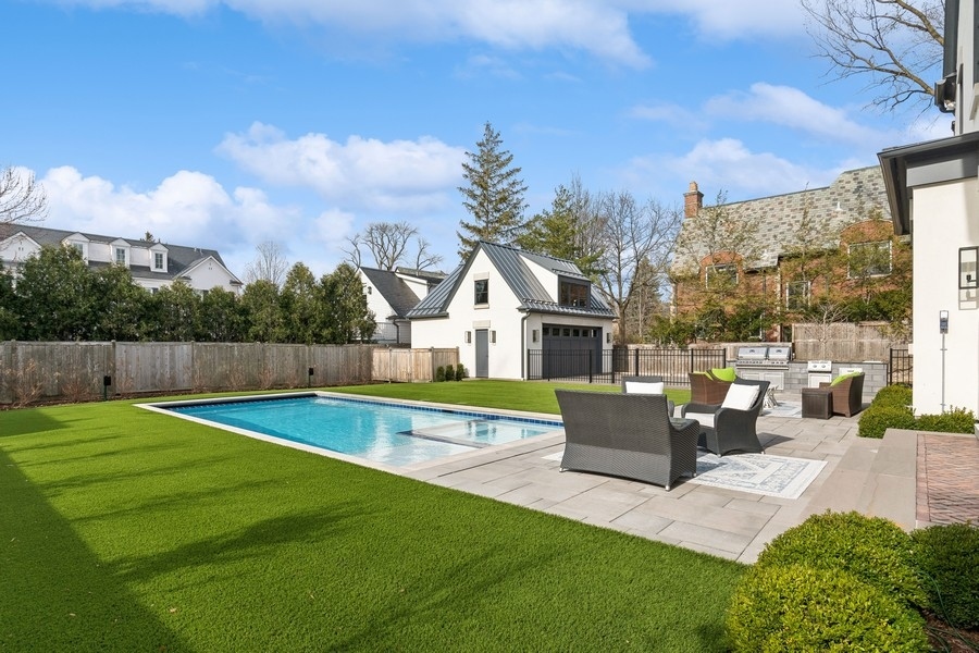240 Raleigh Road Kenilworth, IL 60043 - Photo 63 of 71 a view of a house with pool and a yard