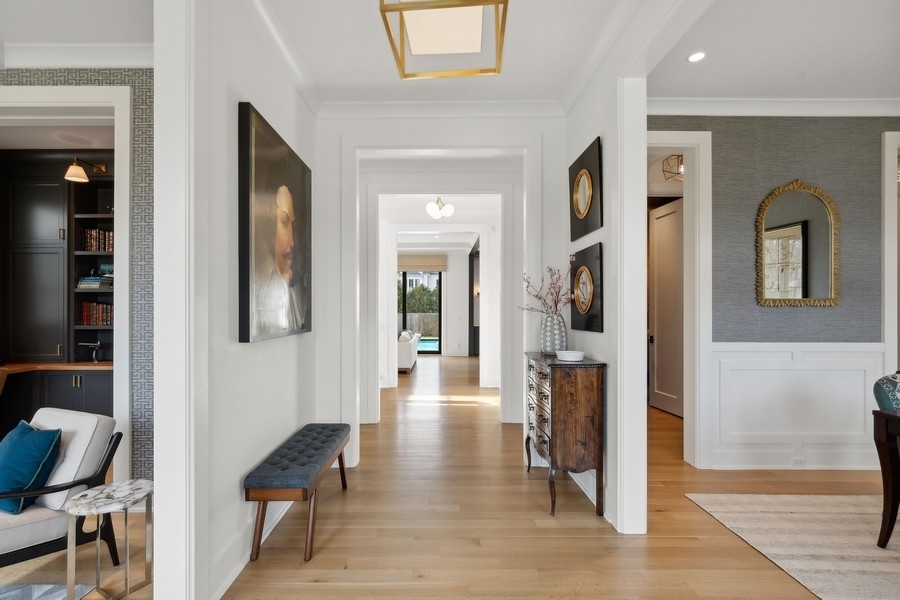 240 Raleigh Road Kenilworth, IL 60043 - Photo 7 of 71 a hallway with wooden floor and a dining table