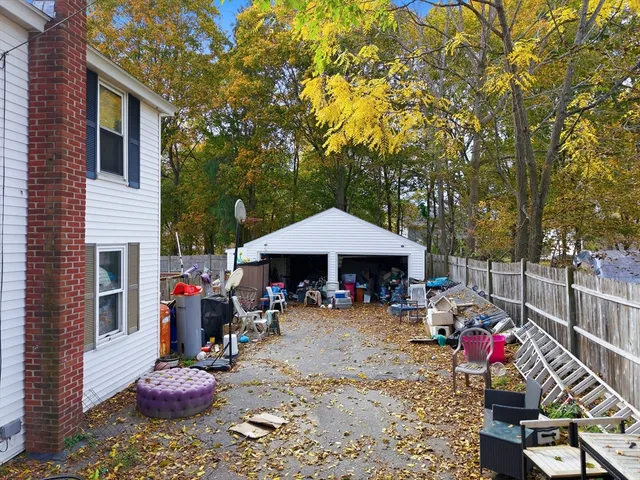a view of a patio with table and chairs under an umbrella