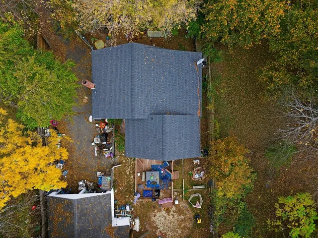 an aerial view of a house with a yard