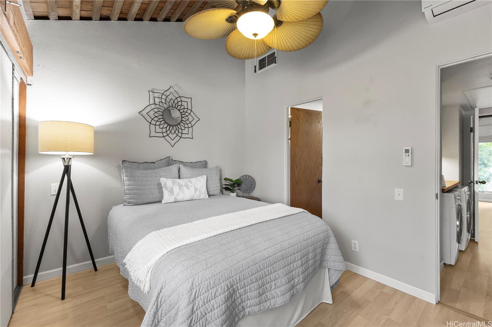 445 Kawailoa Road, Unit 8 Kailua, HI 96734 - Photo 11 of 25 a bedroom with a bed and a chandelier