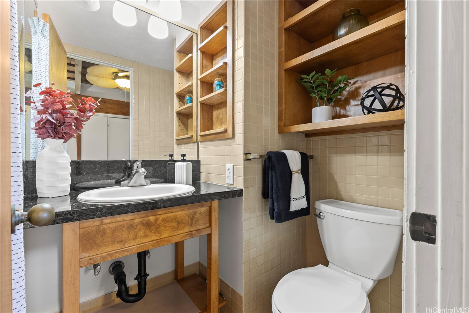 445 Kawailoa Road, Unit 8 Kailua, HI 96734 - Photo 15 of 25 a bathroom with a toilet sink and mirror