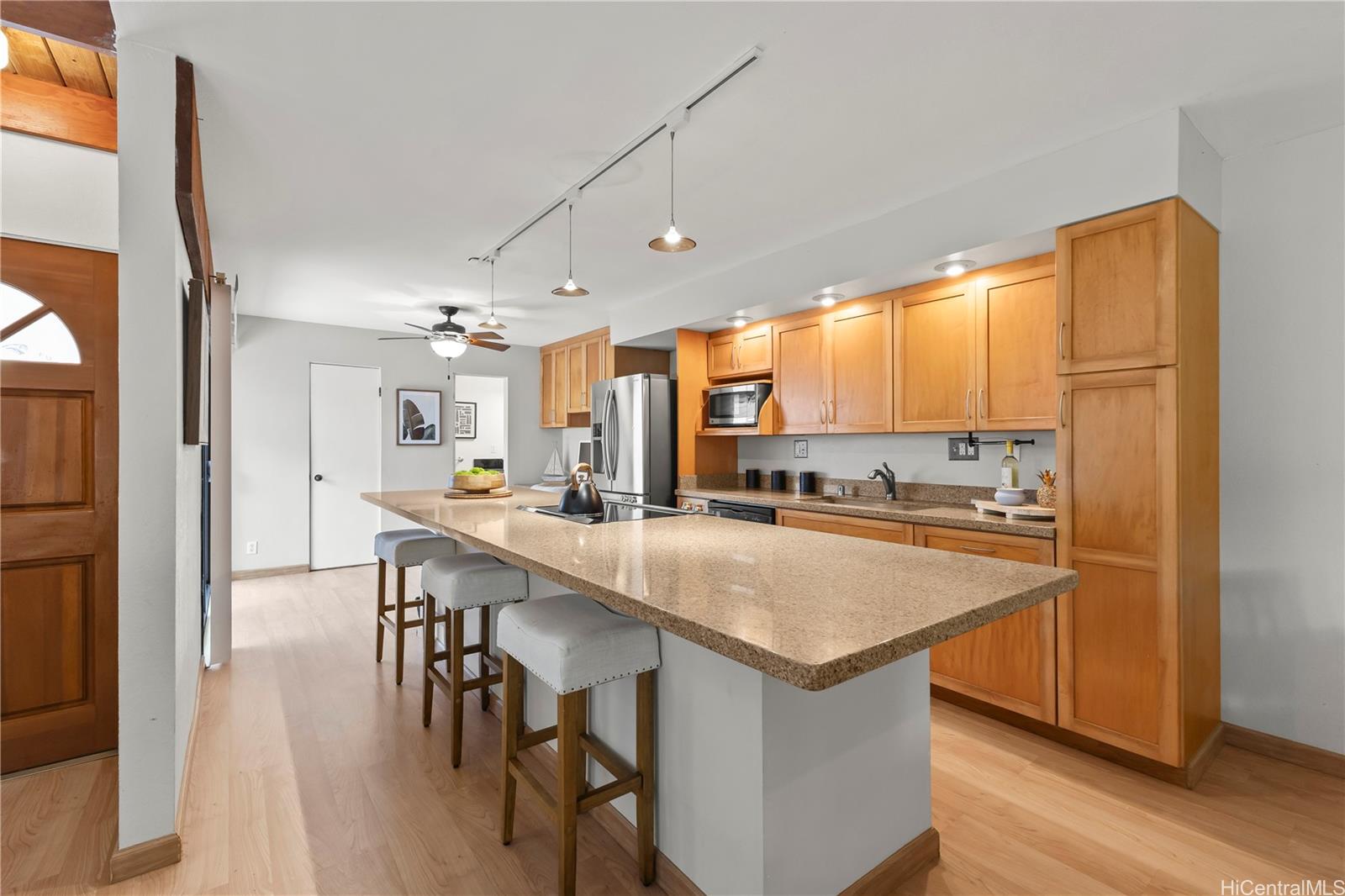 445 Kawailoa Road, Unit 8 Kailua, HI 96734 - Photo 8 of 25 a open kitchen with stainless steel appliances granite countertop a stove top oven a sink dishwasher and a refrigerator with wooden floor