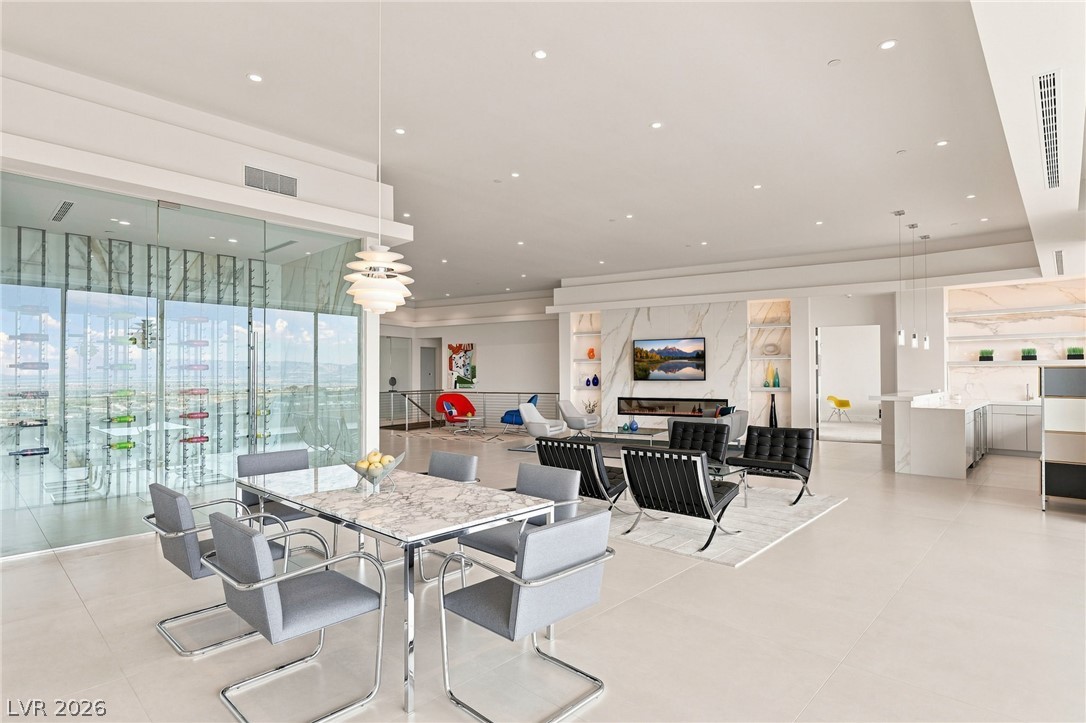 677 Overlook Rim Drive Henderson, NV 89012 - Photo 17 of 97 Polished tile flooring and recessed lighting define this expansive open-concept living and dining space.