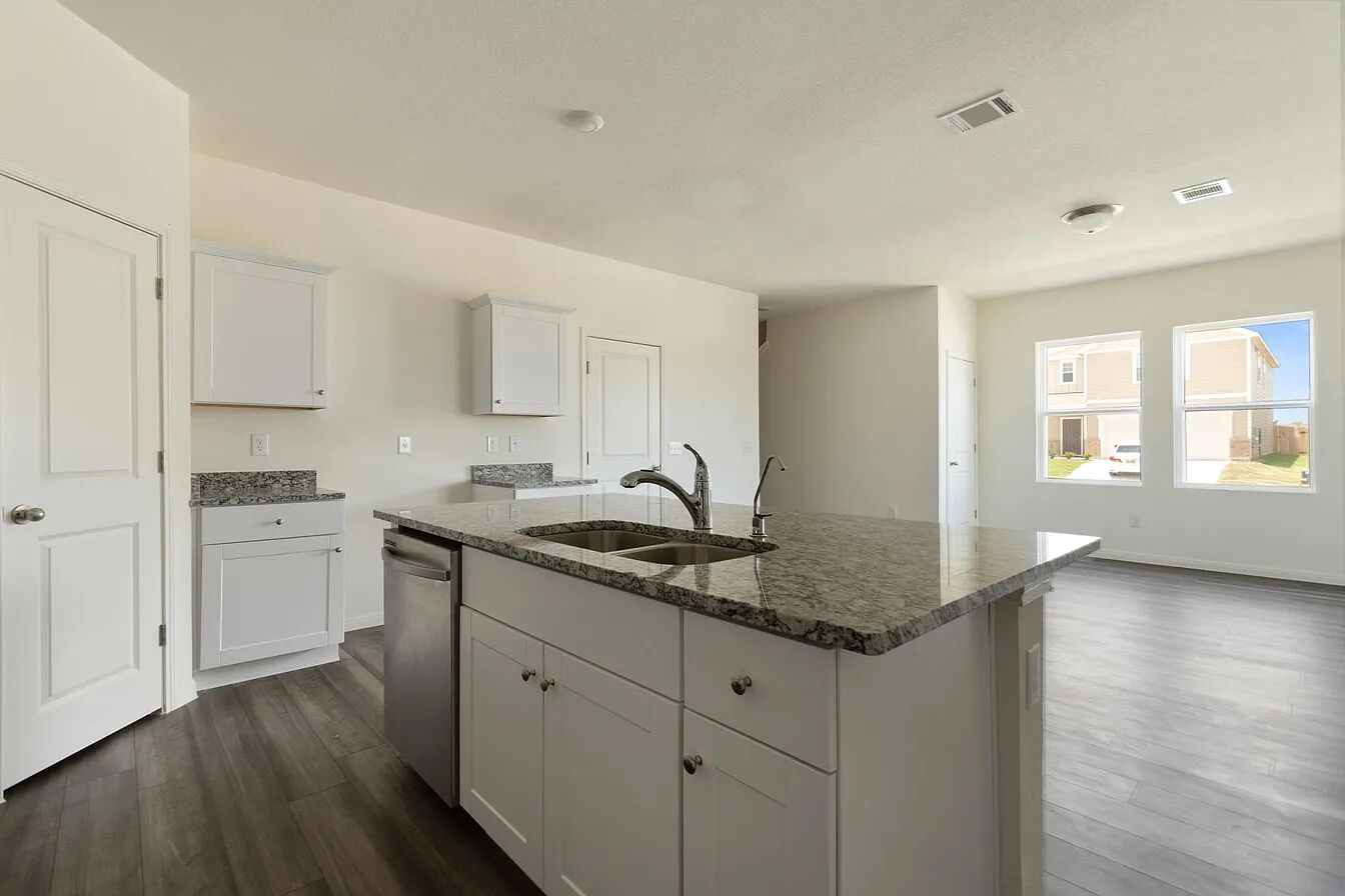 101 Aoudad Road Hutto, TX 78634 - Photo 10 of 39 A well-lit kitchen with sleek countertops and ample cabinetry, offering an ideal space for culinary pursuits.