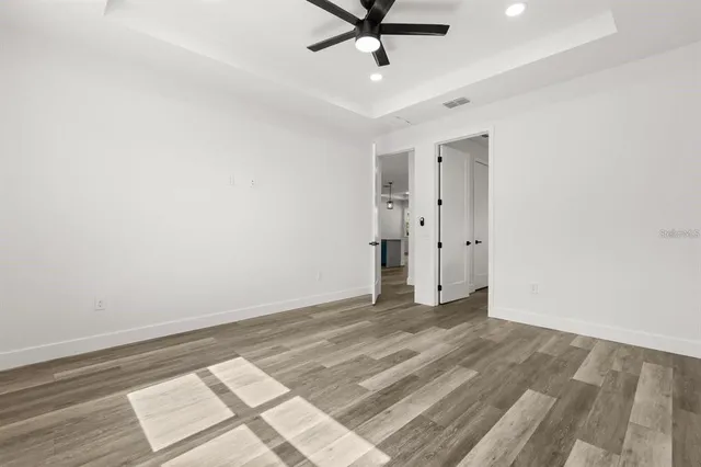a spacious bathroom with a double vanity sink a mirror and a bathtub