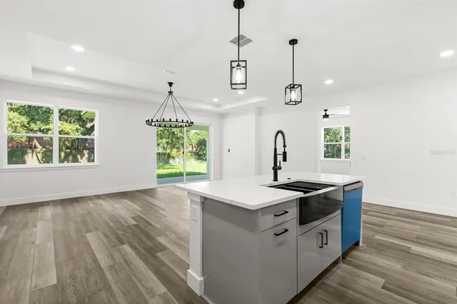 a bedroom with a large bed and a potted plant