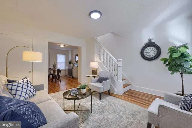 a living room with furniture a clock and a chandelier
