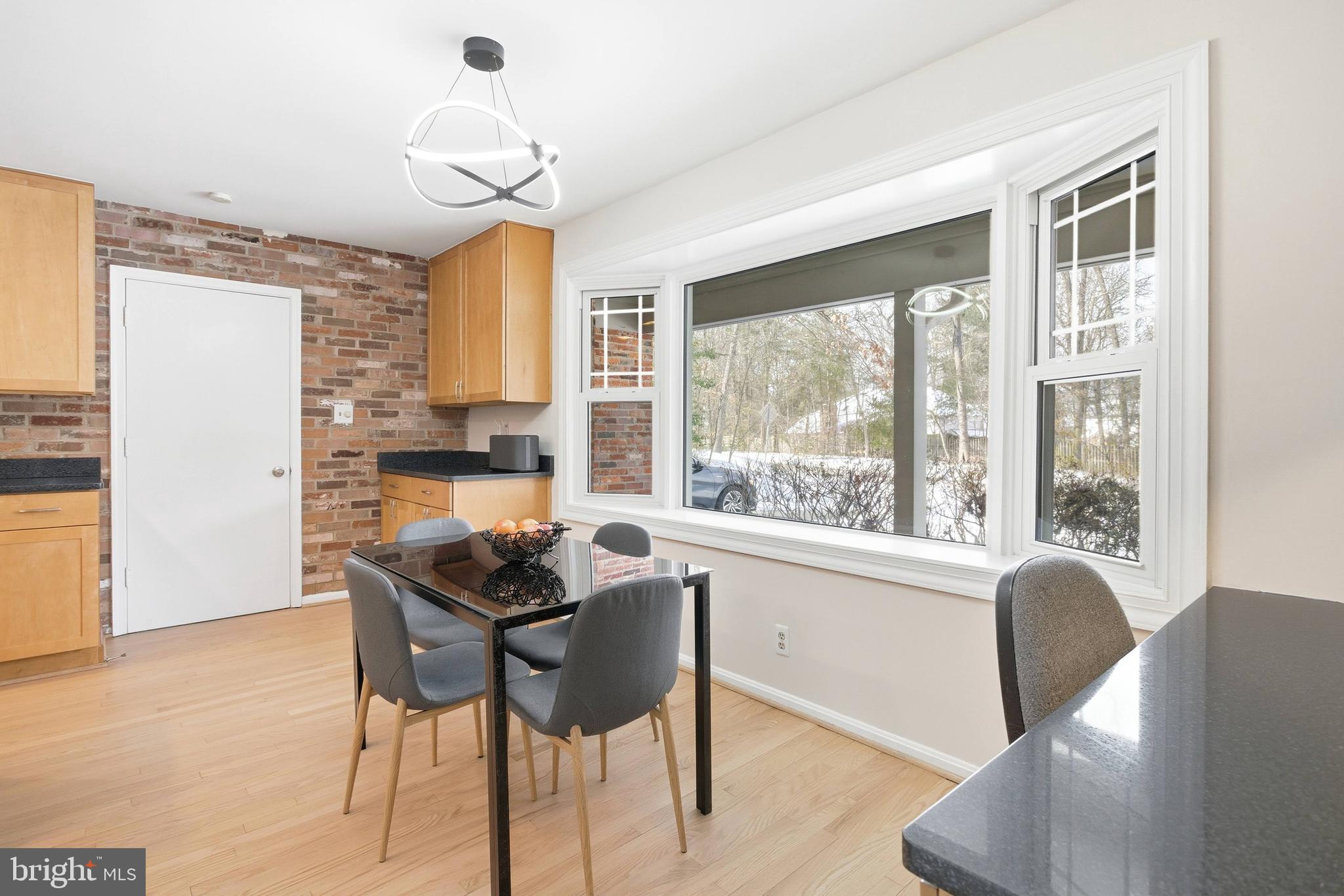 521 Creek Crossing Road Northeast Vienna, VA 22180 - Photo 11 of 63 a dining room with furniture a chandelier and wooden floor