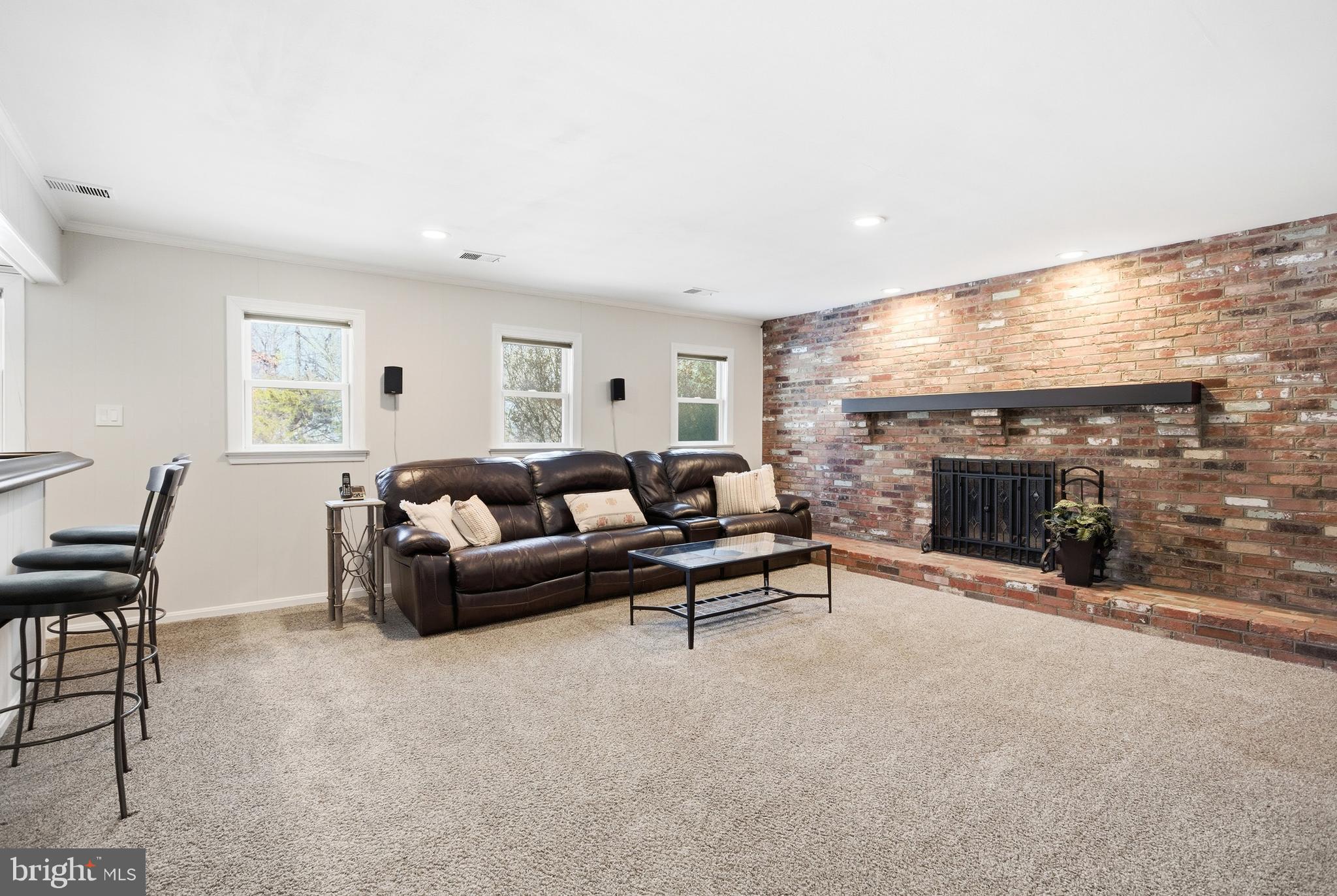 521 Creek Crossing Road Northeast Vienna, VA 22180 - Photo 43 of 63 a living room with furniture a fireplace and a flat screen tv