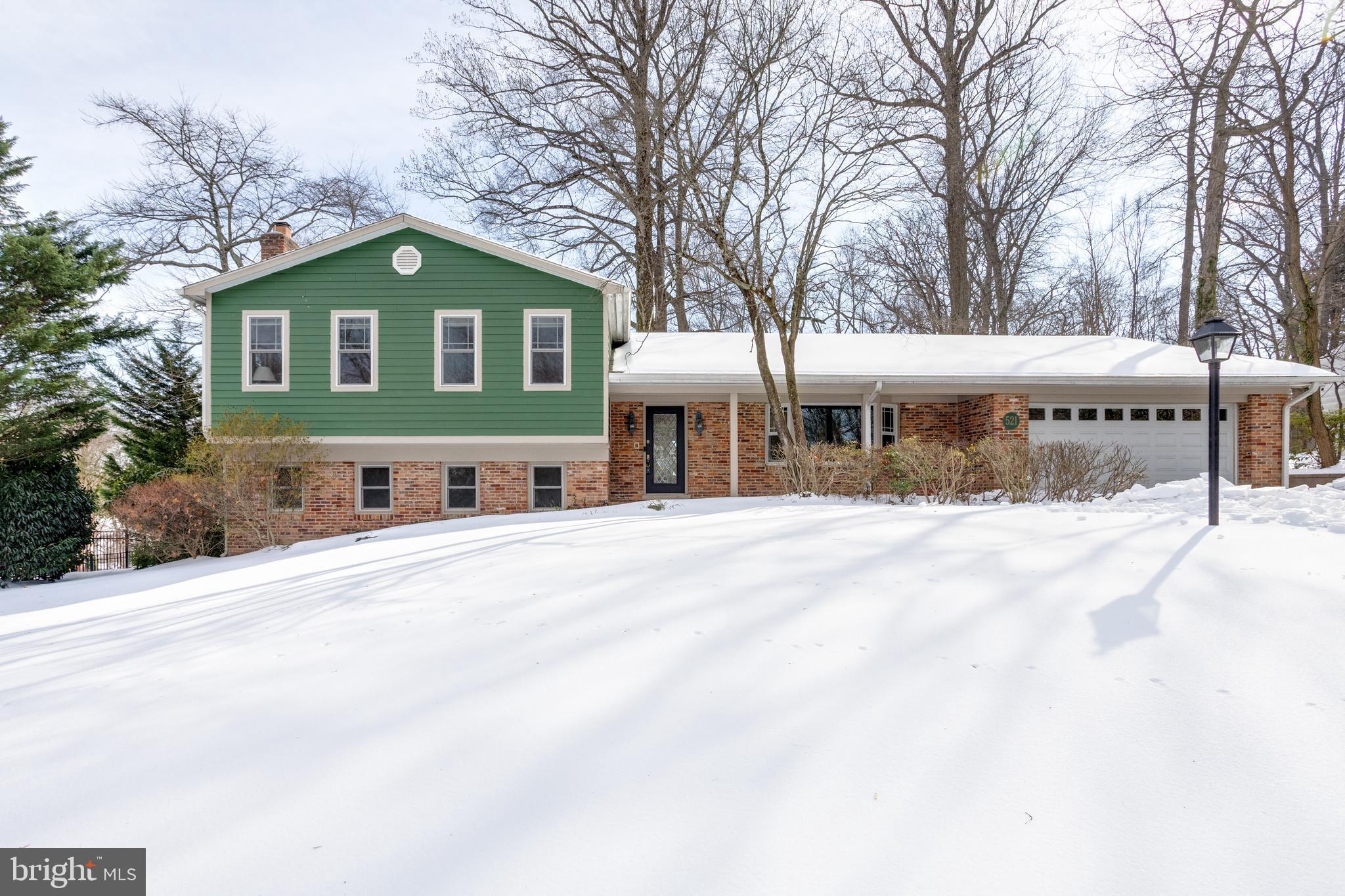 521 Creek Crossing Road Northeast Vienna, VA 22180 - Photo 6 of 63 a view of a house with a yard covered with snow in front of house