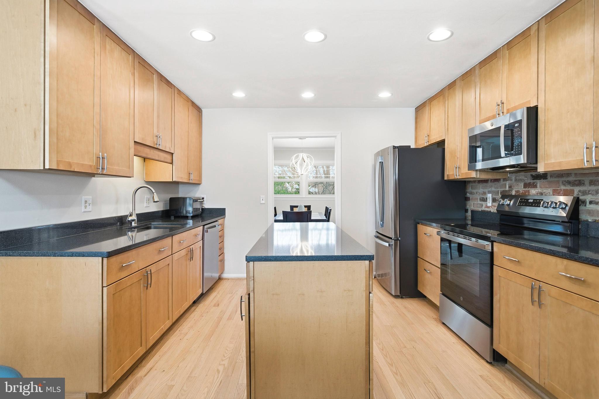 521 Creek Crossing Road Northeast Vienna, VA 22180 - Photo 10 of 63 a kitchen with stainless steel appliances granite countertop a refrigerator a stove top oven a sink and dishwasher