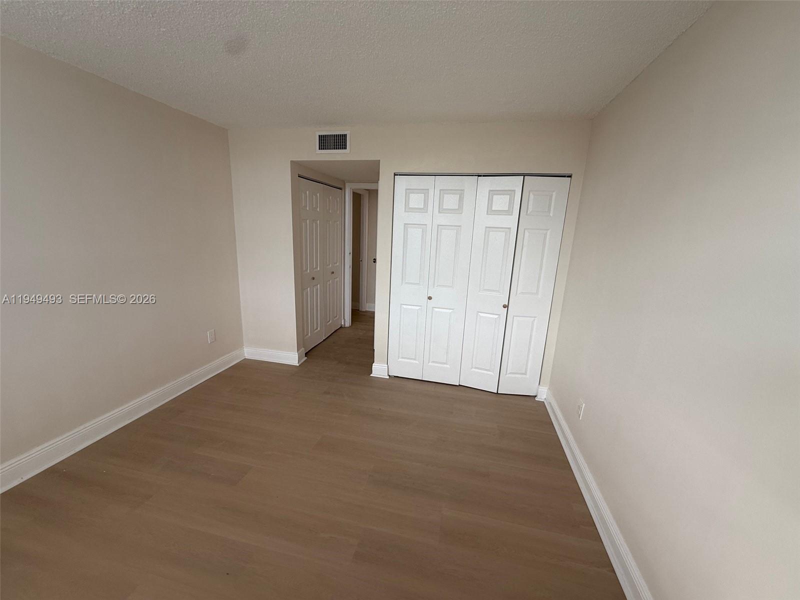 484 Northwest 165th St Road, Unit A512 Miami, FL 33169 - Photo 11 of 16 wooden floor in an empty room
