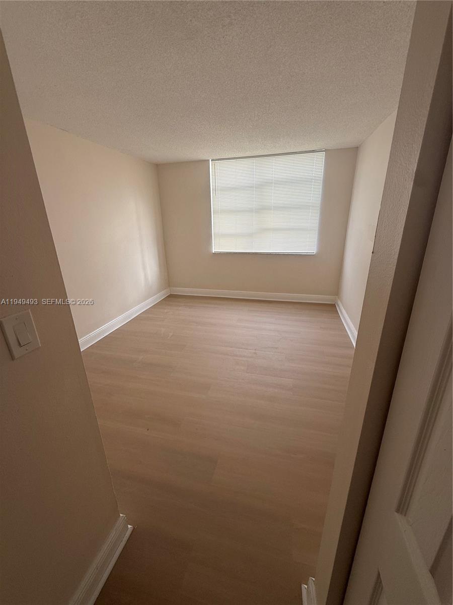 484 Northwest 165th St Road, Unit A512 Miami, FL 33169 - Photo 12 of 16 an empty room with windows