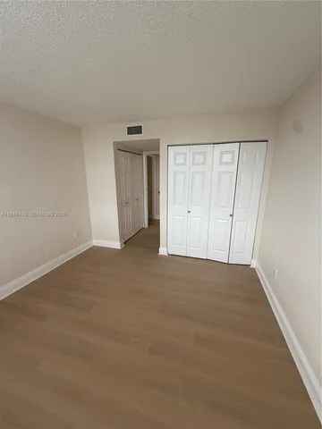 a view of an empty room and wooden floor