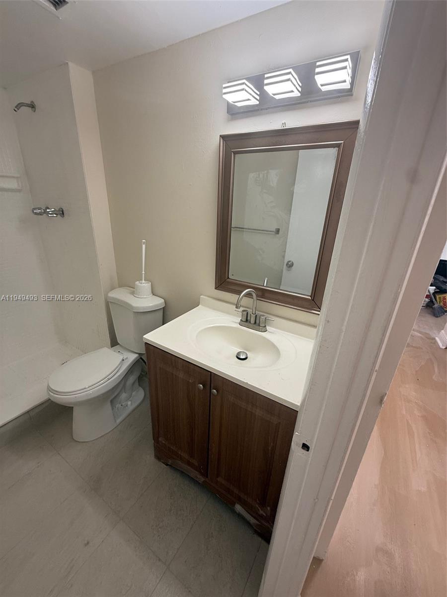 484 Northwest 165th St Road, Unit A512 Miami, FL 33169 - Photo 15 of 16 a bathroom with a toilet sink and mirror