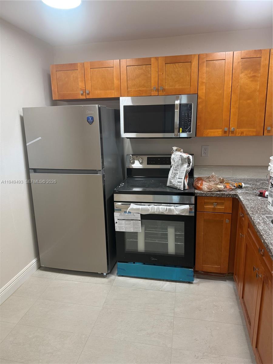 484 Northwest 165th St Road, Unit A512 Miami, FL 33169 - Photo 2 of 16 a kitchen with a sink a stove and a refrigerator