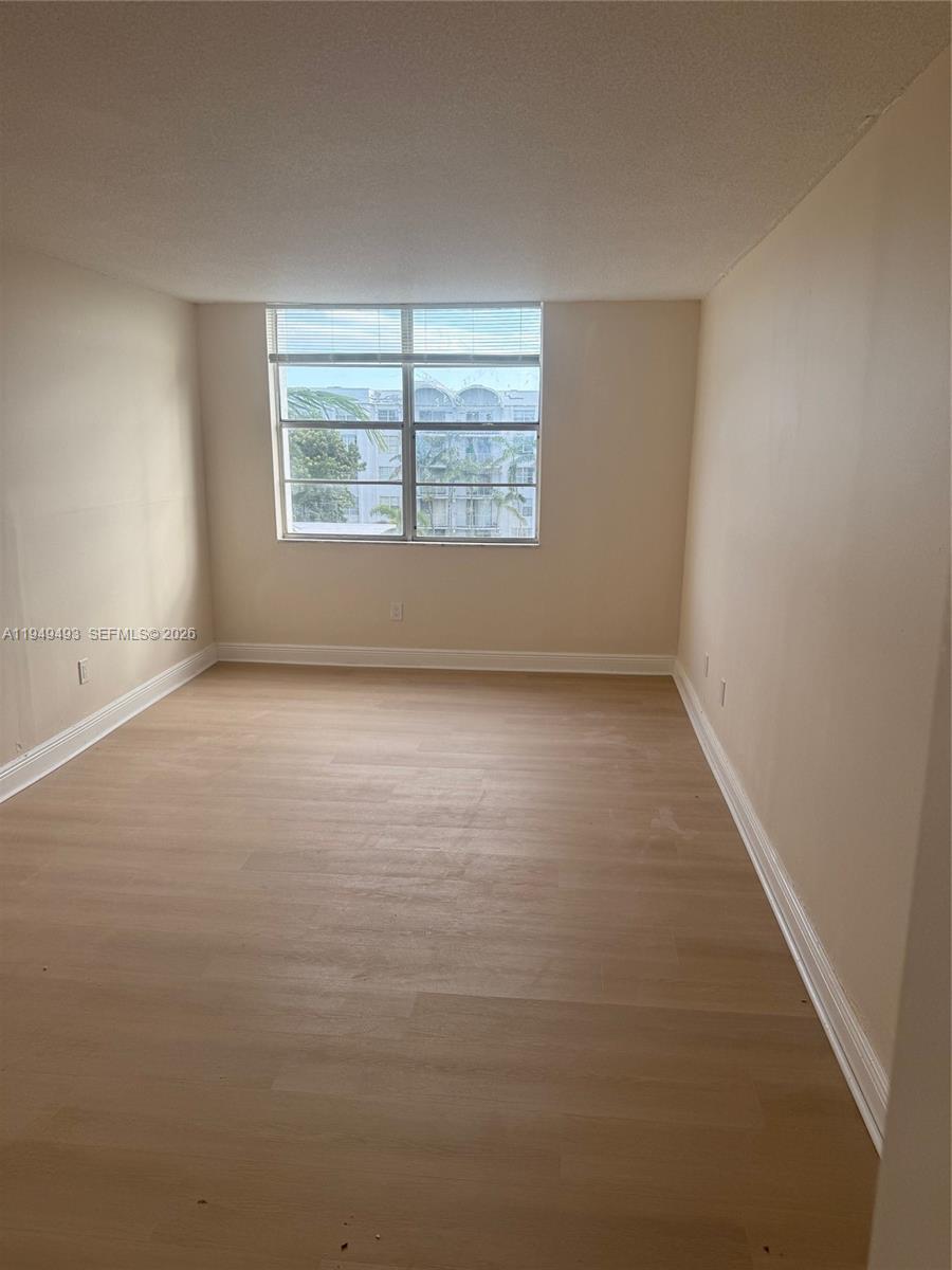 484 Northwest 165th St Road, Unit A512 Miami, FL 33169 - Photo 6 of 16 an empty room with windows