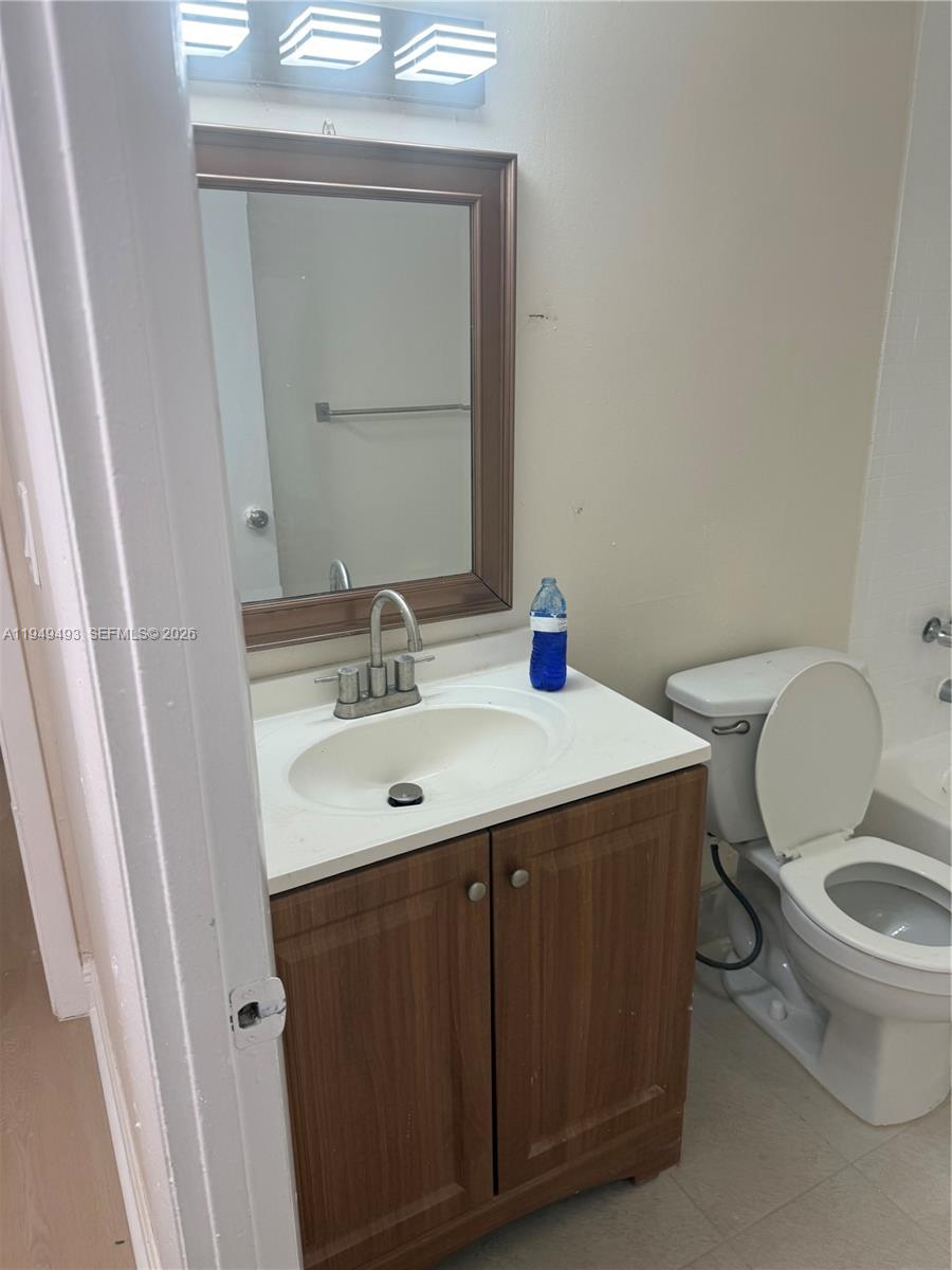 484 Northwest 165th St Road, Unit A512 Miami, FL 33169 - Photo 7 of 16 a bathroom with a sink toilet and mirror