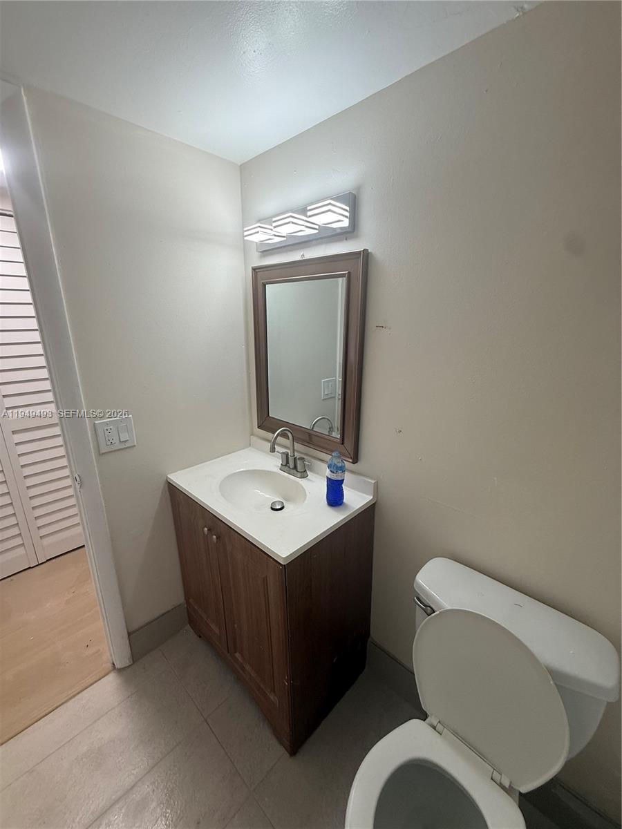484 Northwest 165th St Road, Unit A512 Miami, FL 33169 - Photo 8 of 16 a bathroom with a toilet sink and mirror