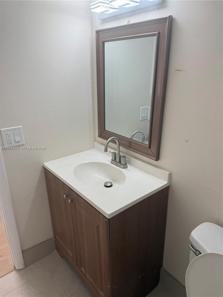 484 Northwest 165th St Road, Unit A512 Miami, FL 33169 - Photo 9 of 16 a bathroom with a sink vanity and a toilet