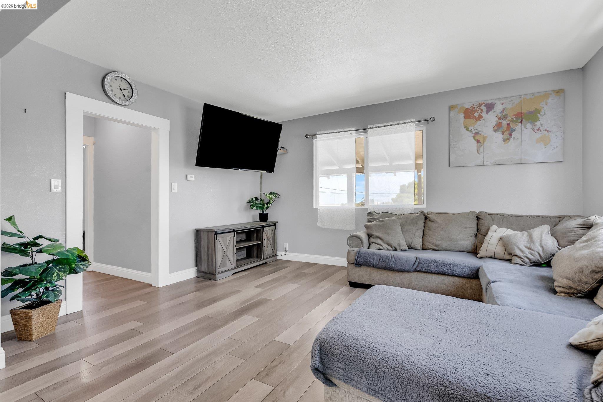 2350 West Shell Avenue Martinez, CA 94553 - Photo 12 of 39 a living room with furniture a flat screen tv and a potted plant