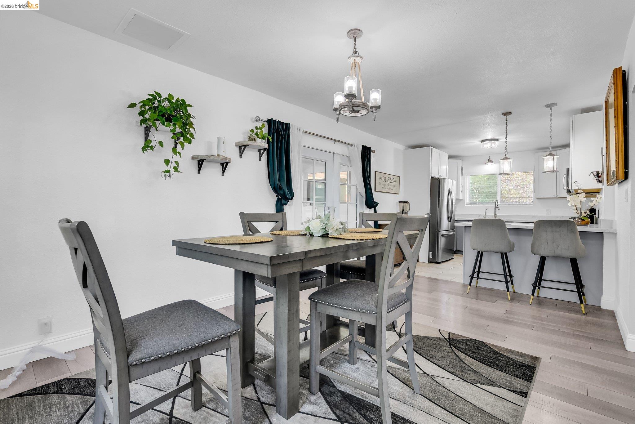 2350 West Shell Avenue Martinez, CA 94553 - Photo 13 of 39 a view of a dining room with furniture a chandelier and wooden floor