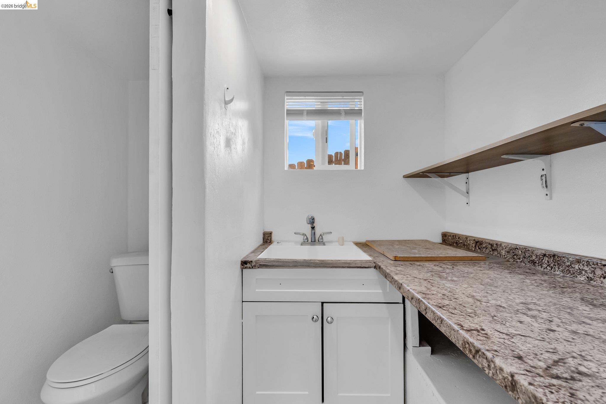 2350 West Shell Avenue Martinez, CA 94553 - Photo 30 of 39 a bathroom with a granite countertop sink a toilet and a mirror