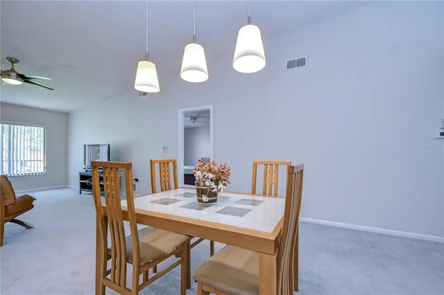 a view of a dining room with furniture and window