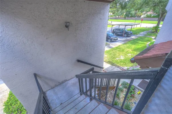 a view of a balcony with floor to ceiling windows with wooden floor