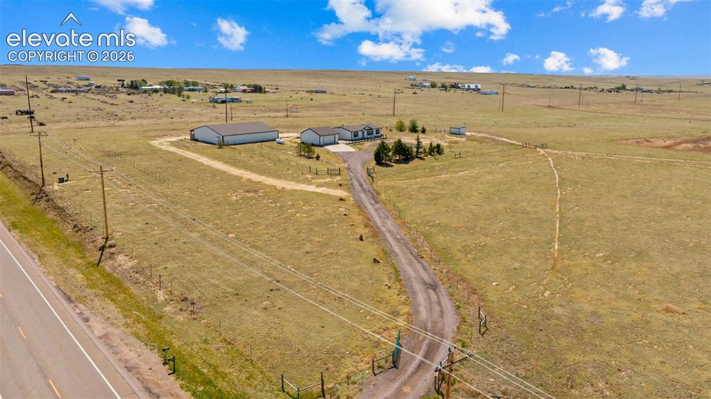 33975 Highway 94 Yoder, CO 80864 - Photo 37 of 40 Expansive rural property featuring a primary residence, a large outbuilding with a dark roof, and a separate smaller structure