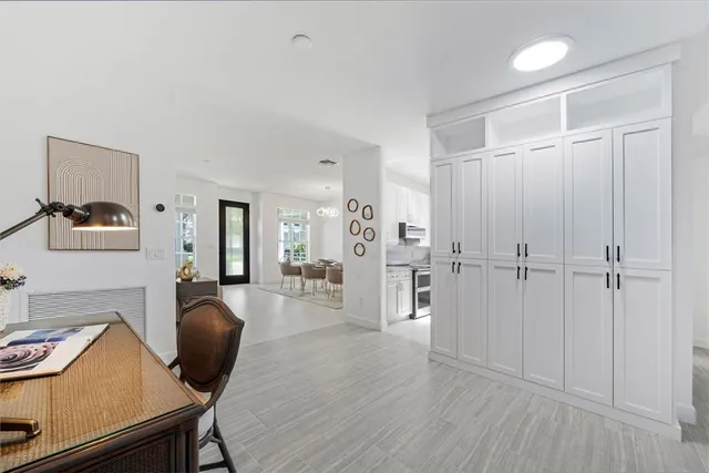 a en suite bathroom with a granite countertop sink a toilet a mirror and a window