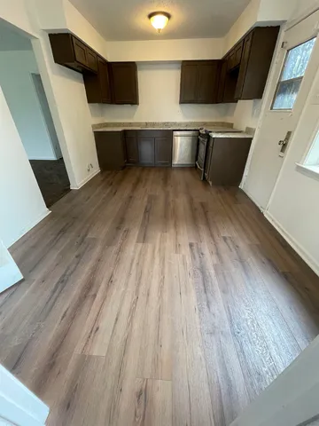a kitchen with stainless steel appliances a refrigerator and a stove top oven
