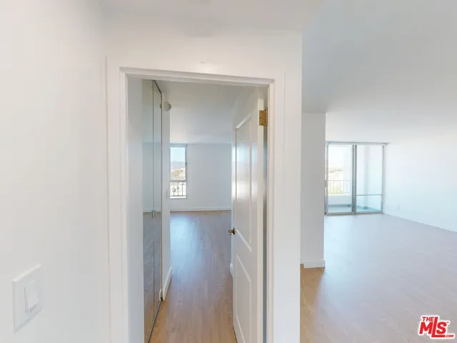 a view of hallway with wooden floor