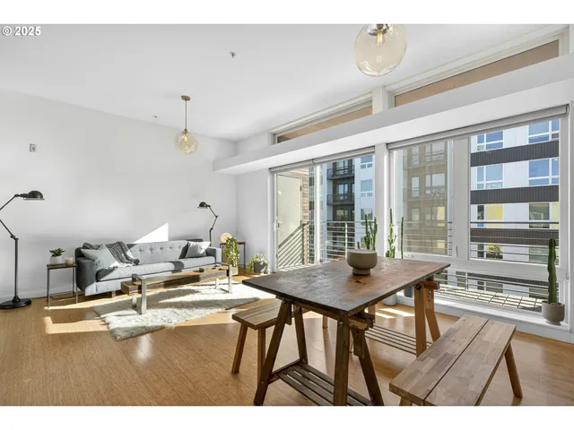 a view of a dining room with furniture large windows and wooden floor