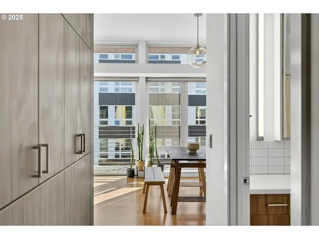 a kitchen view with granite countertop a refrigerator and cabinets