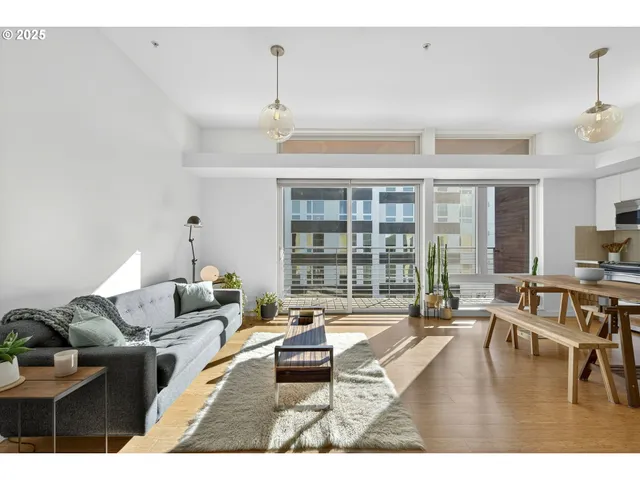 a living room with furniture and a table with wooden floor