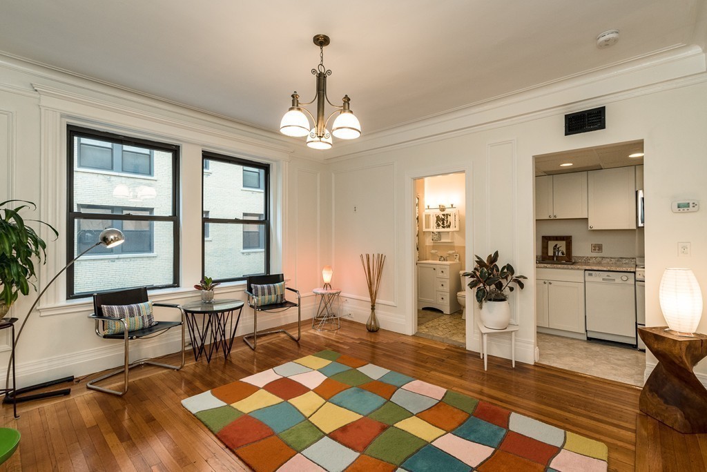 464 Commonwealth Avenue, Unit 38 Boston, MA 02215 - Photo 5 of 16 a living room with dining table a rug a dining table and a large window