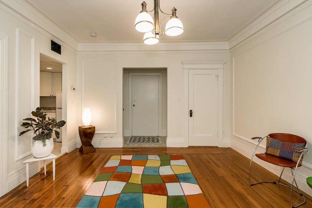 464 Commonwealth Avenue, Unit 38 Boston, MA 02215 - Photo 7 of 16 a bedroom with a bed and wooden floor