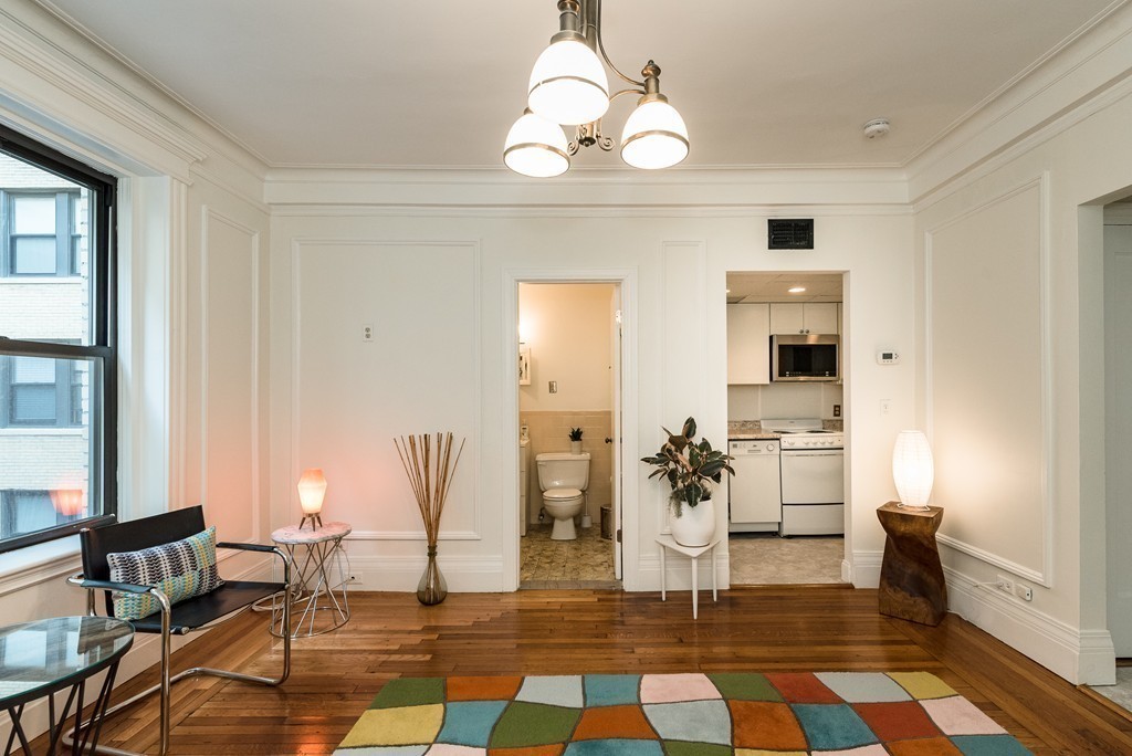 464 Commonwealth Avenue, Unit 38 Boston, MA 02215 - Photo 8 of 16 a living room with patio furniture and a table