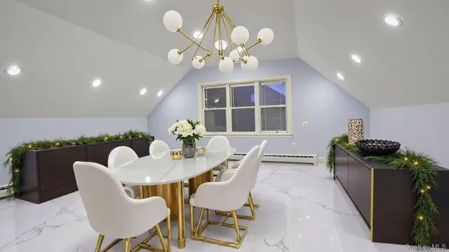a view of a dining room with furniture and chandelier