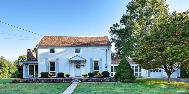a front view of house with yard and green space