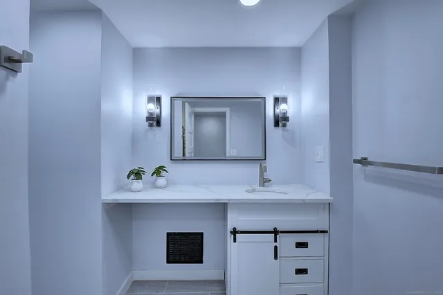 a bathroom with a sink and a mirror